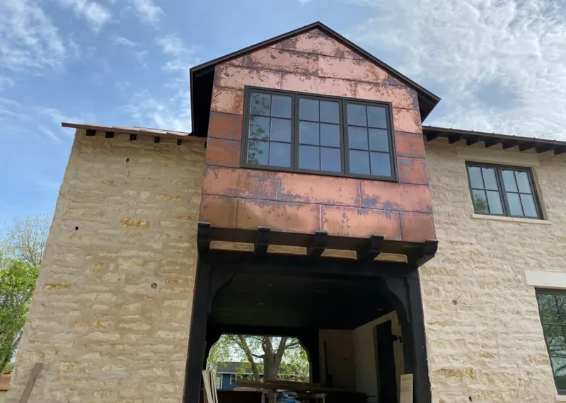 Copper metal panel facade on a stone building for Roof Repair in Los Alamos