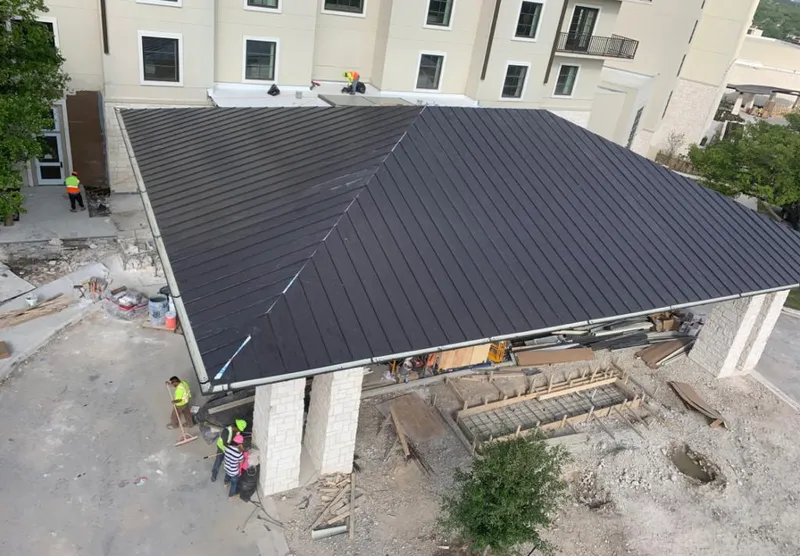 Metal roofing installation team working on a commercial building in Los Alamos